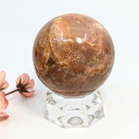 Polished reddish-brown Sunstone Sphere with Peach Moonstone, ideal for spiritual teachers