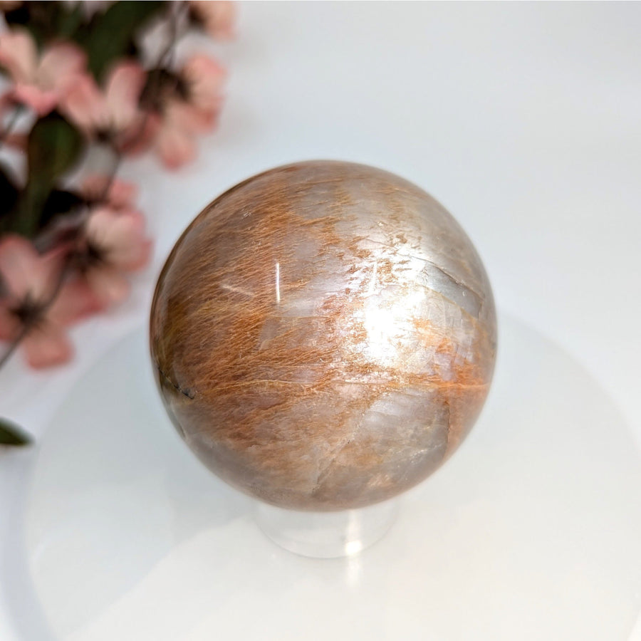 Polished iridescent golden-brown Peach Moonstone 2.3-inch sphere for jewelry or decor