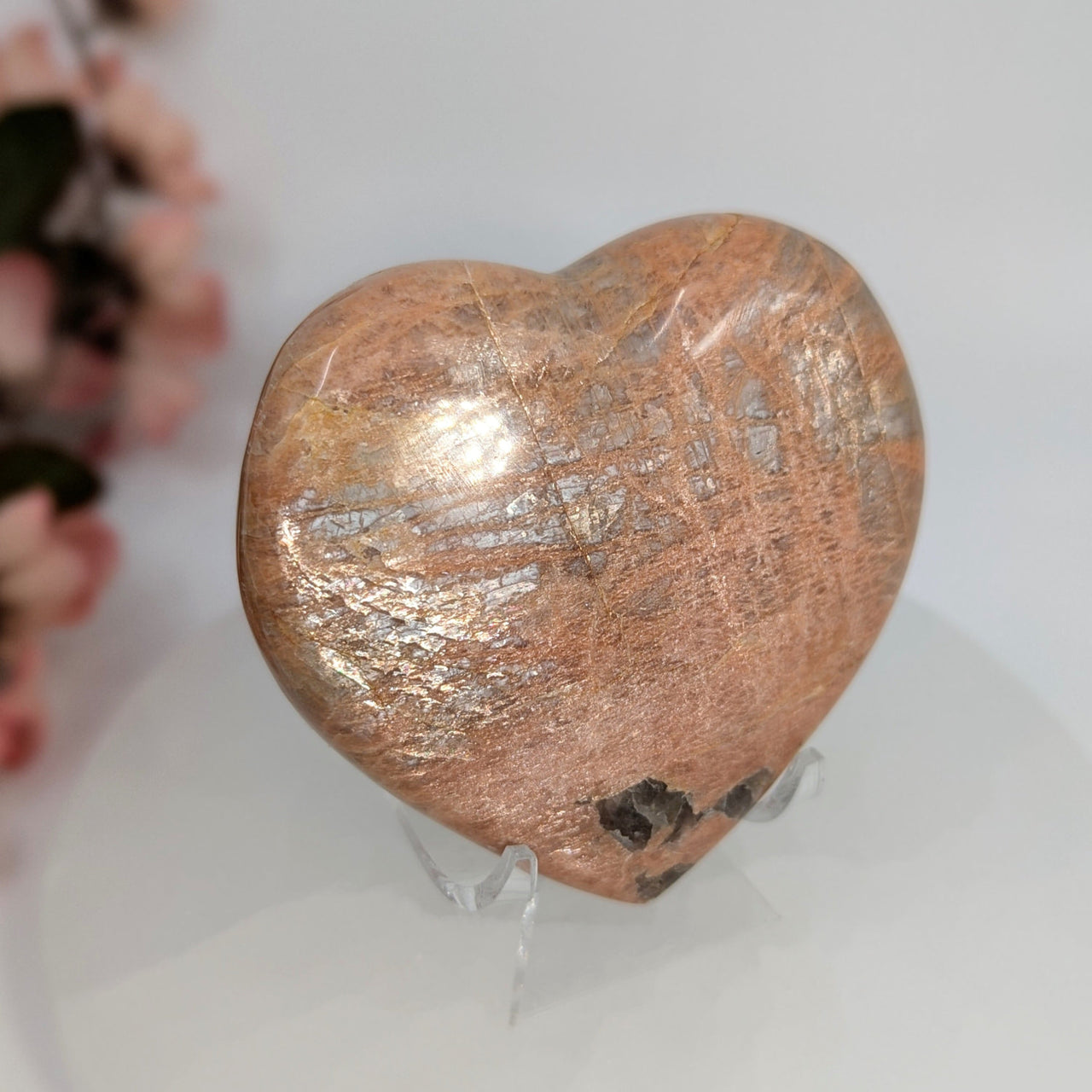 Polished Sunstone Heart displayed with stand in the Peach Moonstone 3-inch Heart product