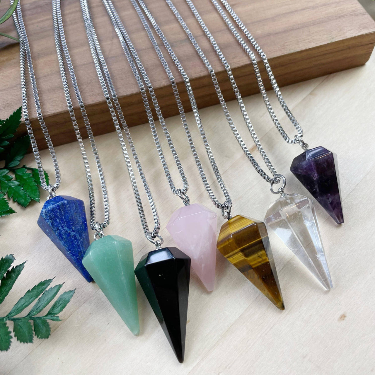 Assorted gemstone pendulum necklaces in blue, green, pink, black, gold, clear, purple, 18’’ silver chain
