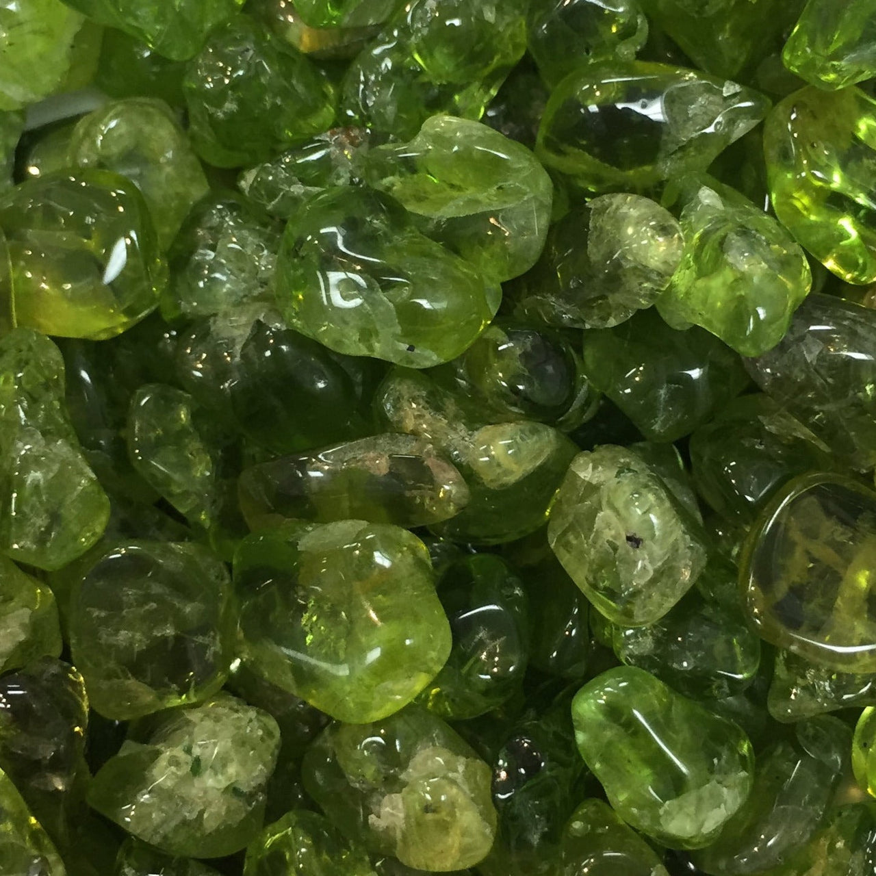 Raw Peridot gemstones showcasing translucent green hues for crystal healing and good fortune