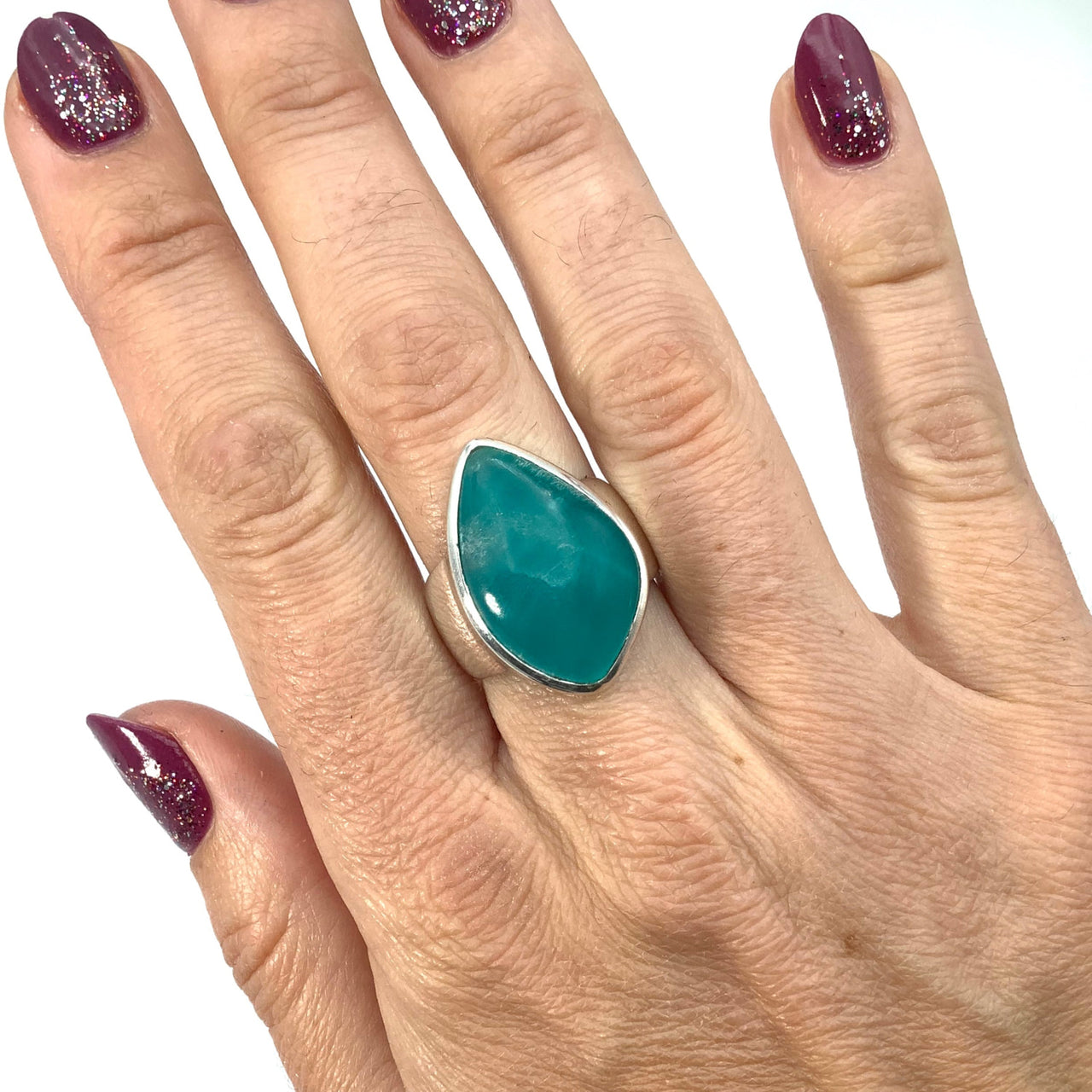 Woman’s hand with green and purple nails wearing Peru Amazonite Ring Size 8