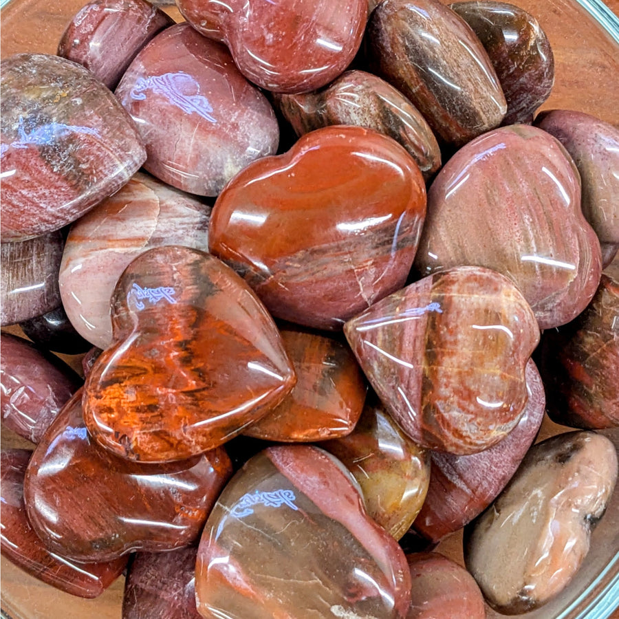 Polished red and brown petrified wood heart-shaped stones for reward notifications display