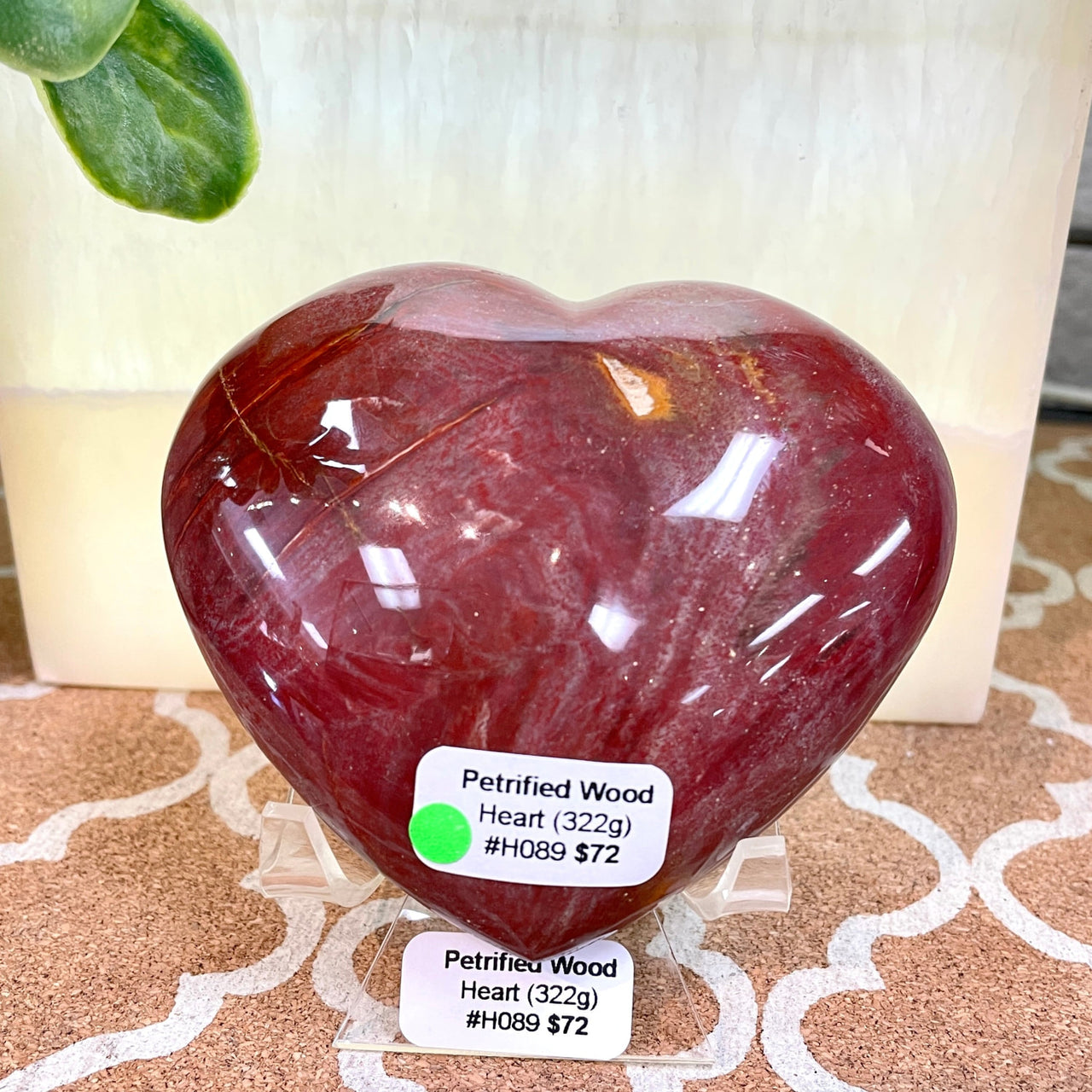 Heart-shaped glass vase labeled ’Petrified Wood Heart #H089’ is elegantly displayed