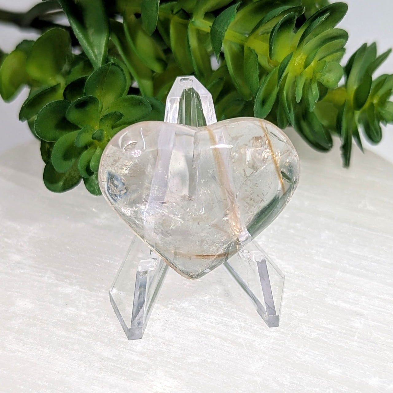 Phantom Amethyst Heart 1.4in quartz crystal with golden inclusions on UV Powellite stand