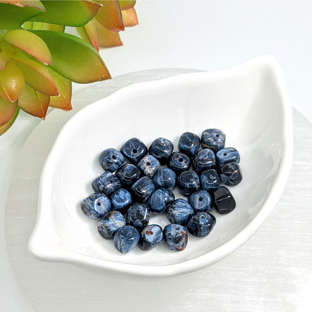 Fresh blueberries in a white dish with Pietersite 7mm Organic Cube Bead design