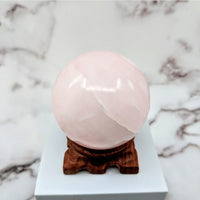 Thumbnail for Pink Calcite 2.8’ Sphere on Stand #LV1801 resembling pink ice cream on white marble surface