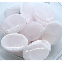 Thumbnail for White glossy soap bars beside Pink Calcite Thumb Stone #P136 for soothing vibes