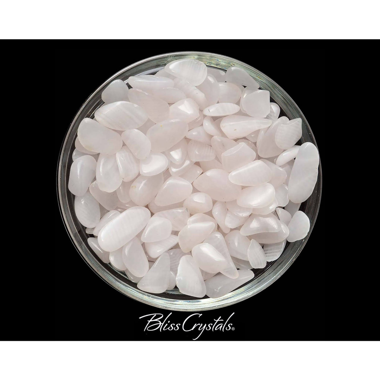 A bowl of white sea glass pebbles with Pink Calcite Tumbled Stone Crystal #PC22