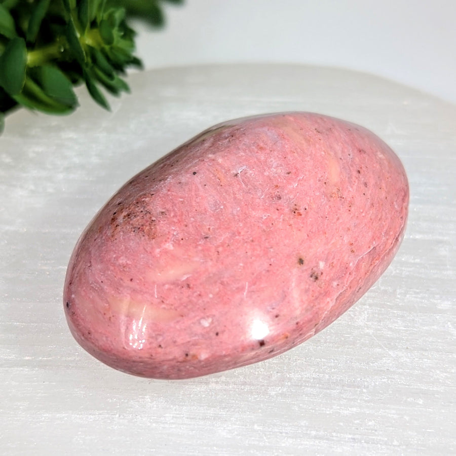 Polished 2.5-inch pink rhodonite palm stone #BC0631 with speckles