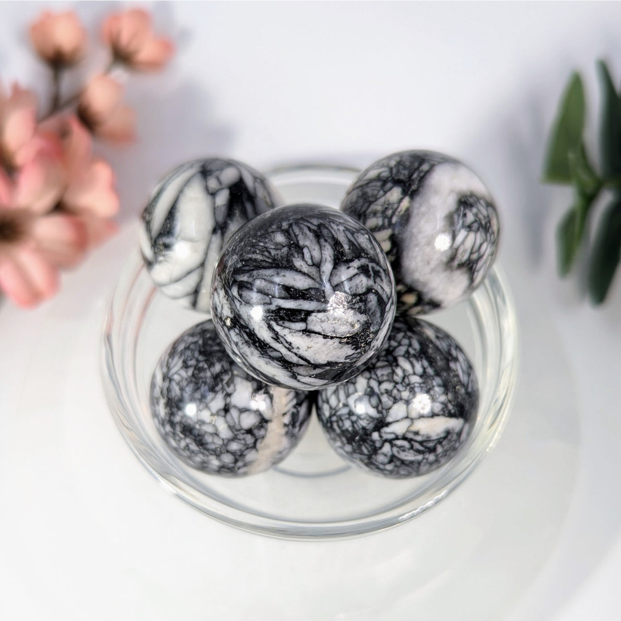 Polished pinolith marble mini spheres in glass bowl