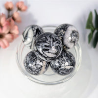 Polished pinolith marble mini spheres in glass bowl