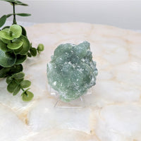 Thumbnail for Close up of a Prehnite 2.5’ rough crystal specimen on a marble table