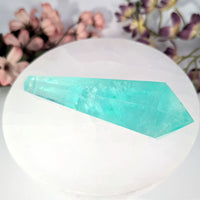 Aquamarine crystal point on white plate with floral background, Private Shop #BC0099