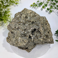 A 5.3 inch natural pyrite cluster with an irregular shape and a metallic gold and silver sheen