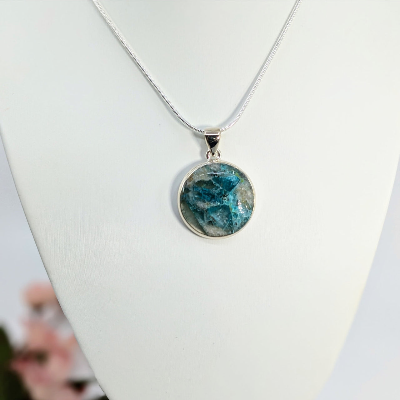 Round Quantum Quattro circle pendant with blue-green stone on delicate chain necklace