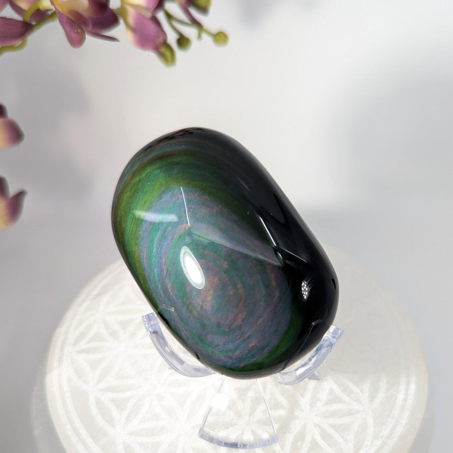 Polished pebble of Rainbow Obsidian with iridescent bands at Bliss Crystals
