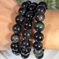 Black onyx 8 inch 12mm bead bracelet with polished gemstones and subtle greenish iridescence jewelry crystals
