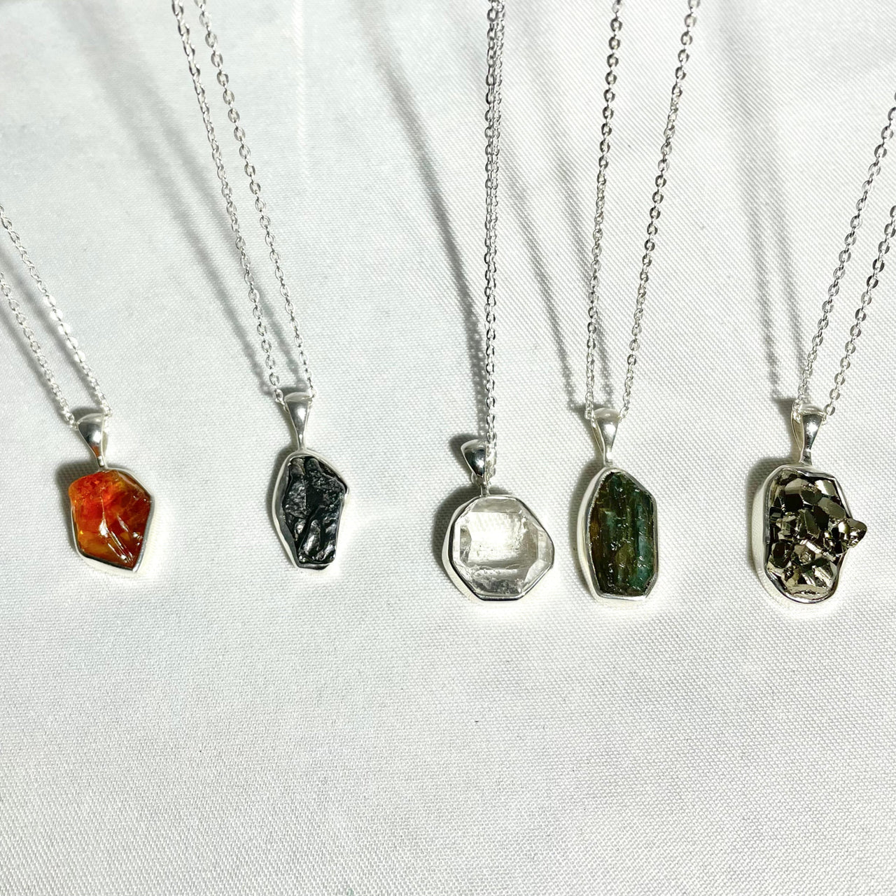 A selection of gems and sterling necklaces radiating positive energy #J814