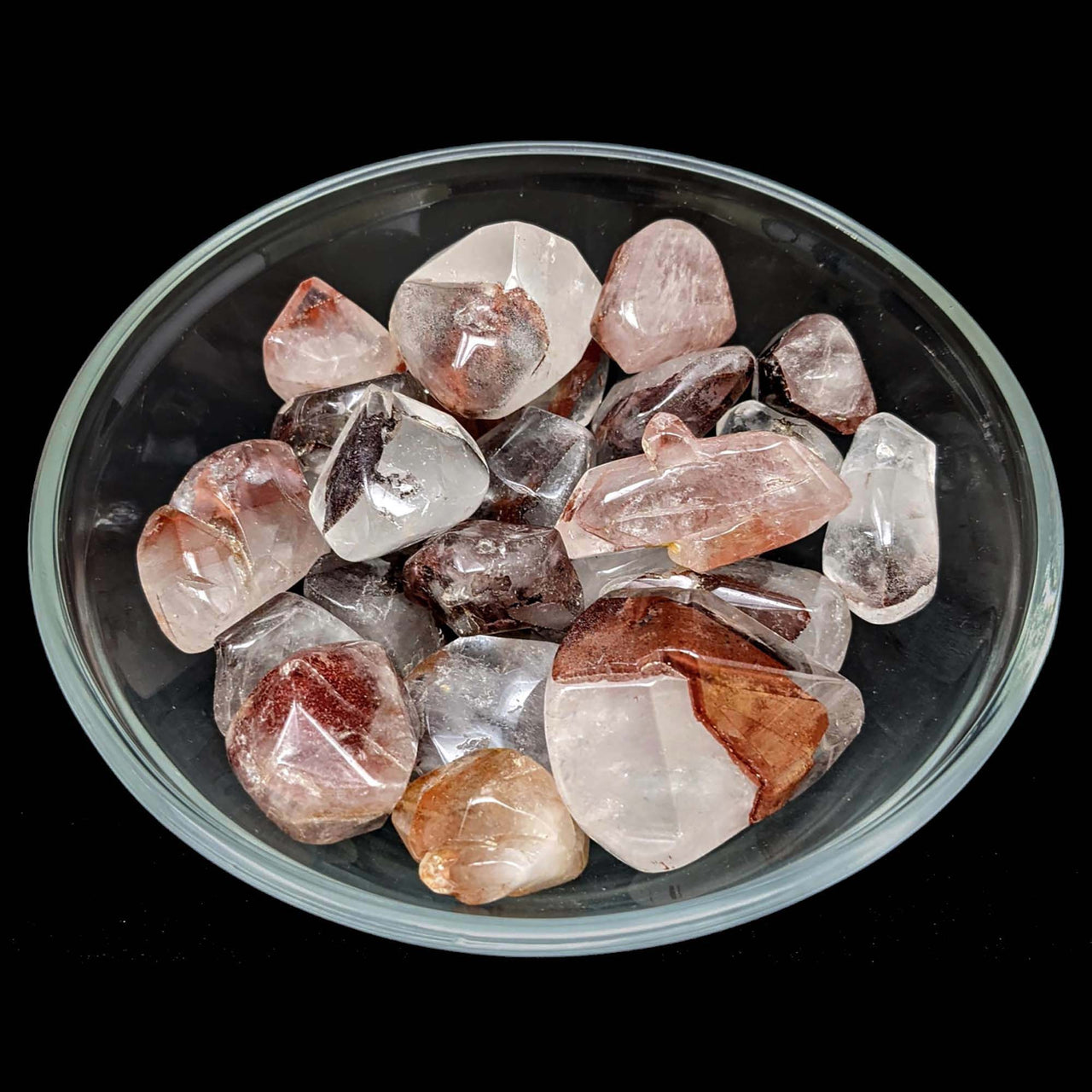 Bowl of Red Phantom Quartz tumbled stones showcasing vibrant colors and unique patterns