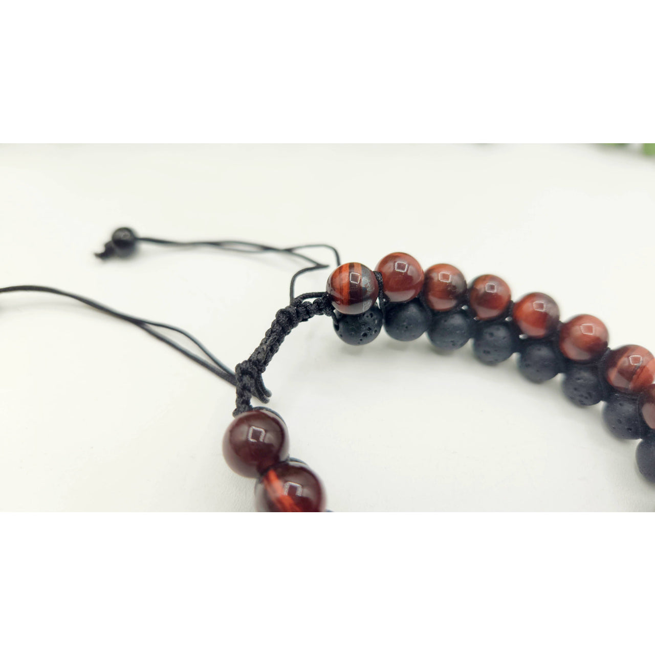 Red and black beaded bracelet featuring Red Tiger Eye and Black Lava woven design