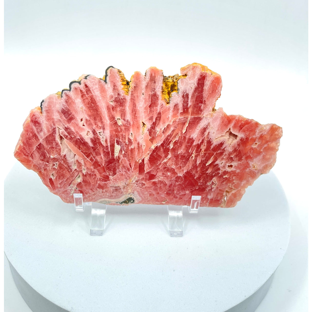 A flat piece of meat on a white plate from Rhodochrosite Slab + Stand #LV1100