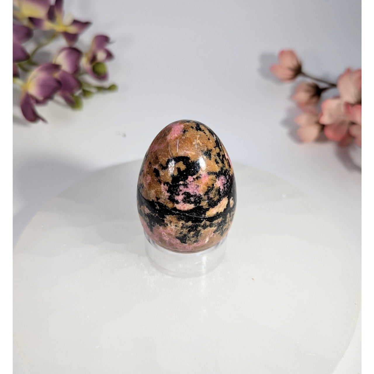 Polished pink and black rhodonite egg 1.5 x 1.75 inches on acrylic stand #BC0469