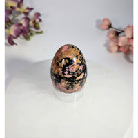 Polished pink and black rhodonite egg 1.5 x 1.75 inches on acrylic stand #BC0469