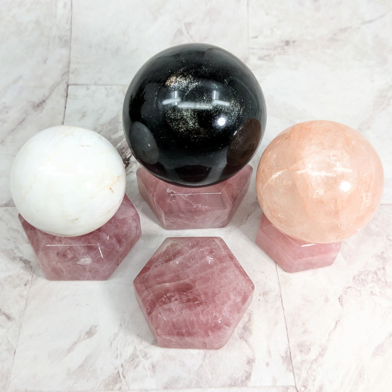Three rose quartz spheres on marble table - Rose Quartz 1.5-2.1’ Sphere Holder #LV2319