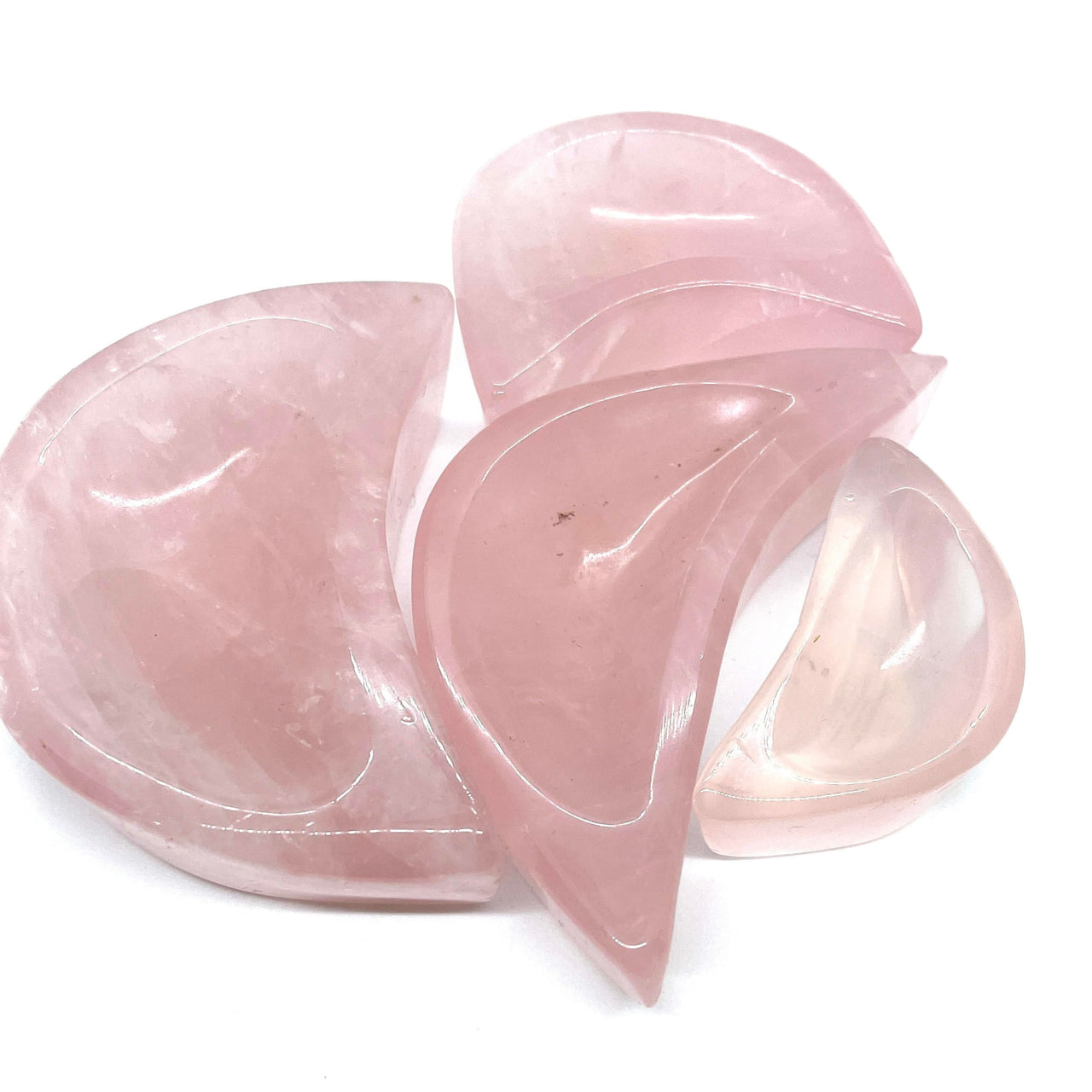 Polished rose quartz crescent moon bowl showcasing smooth, curved surfaces of quartz