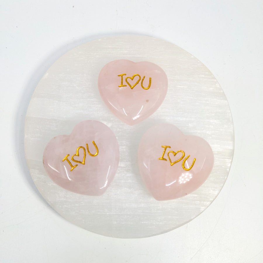 Pink heart-shaped stones with gold lettering for Rose Quartz Heart I Heart U carving
