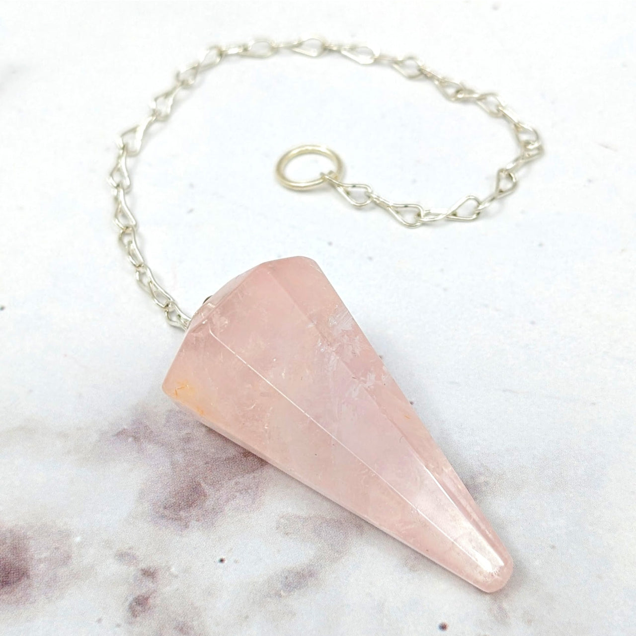 Close-up of pink Rose Quartz Pendulum #J863 on a chain, perfect for divination or healing