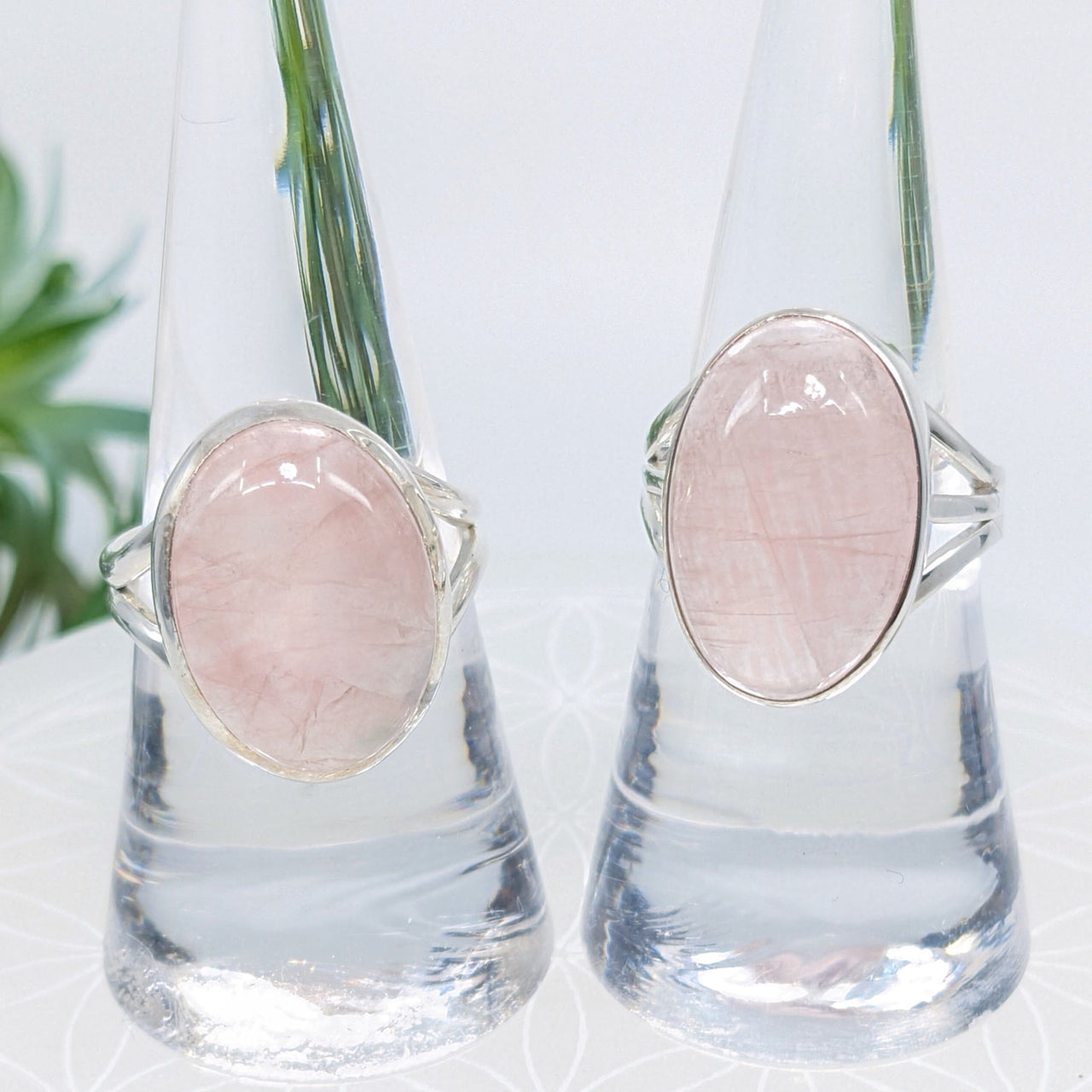 Two silver oval rings with rose quartz gemstones, perfect for elegant jewelry lovers