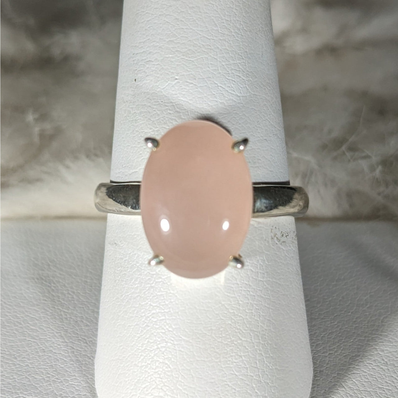 Sterling silver ring with oval-cut rose quartz and pink opal stone in prong setting