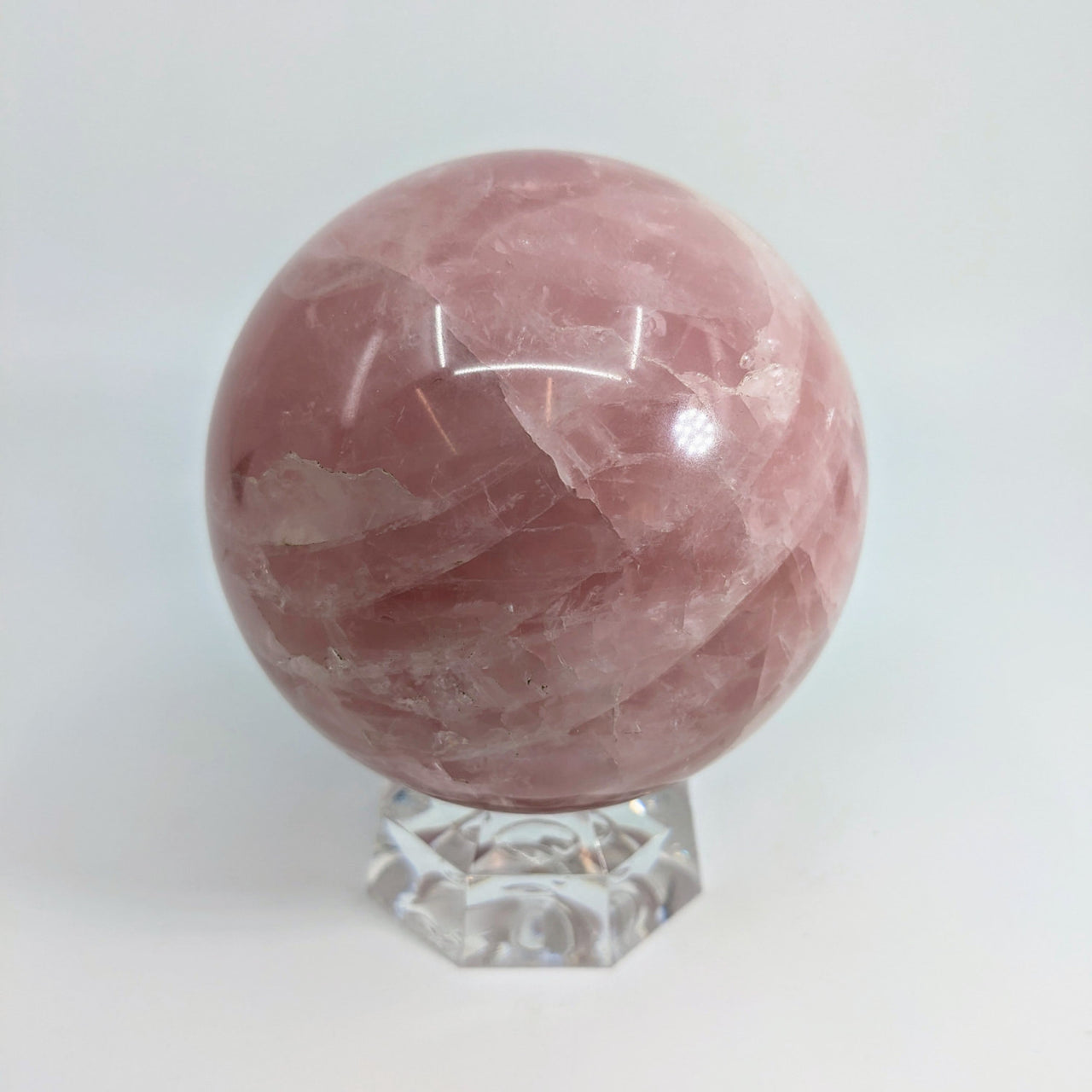 Rose Quartz Sphere 3.5’’ on clear crystal stand showcasing beautiful Rose Quartz Sphere