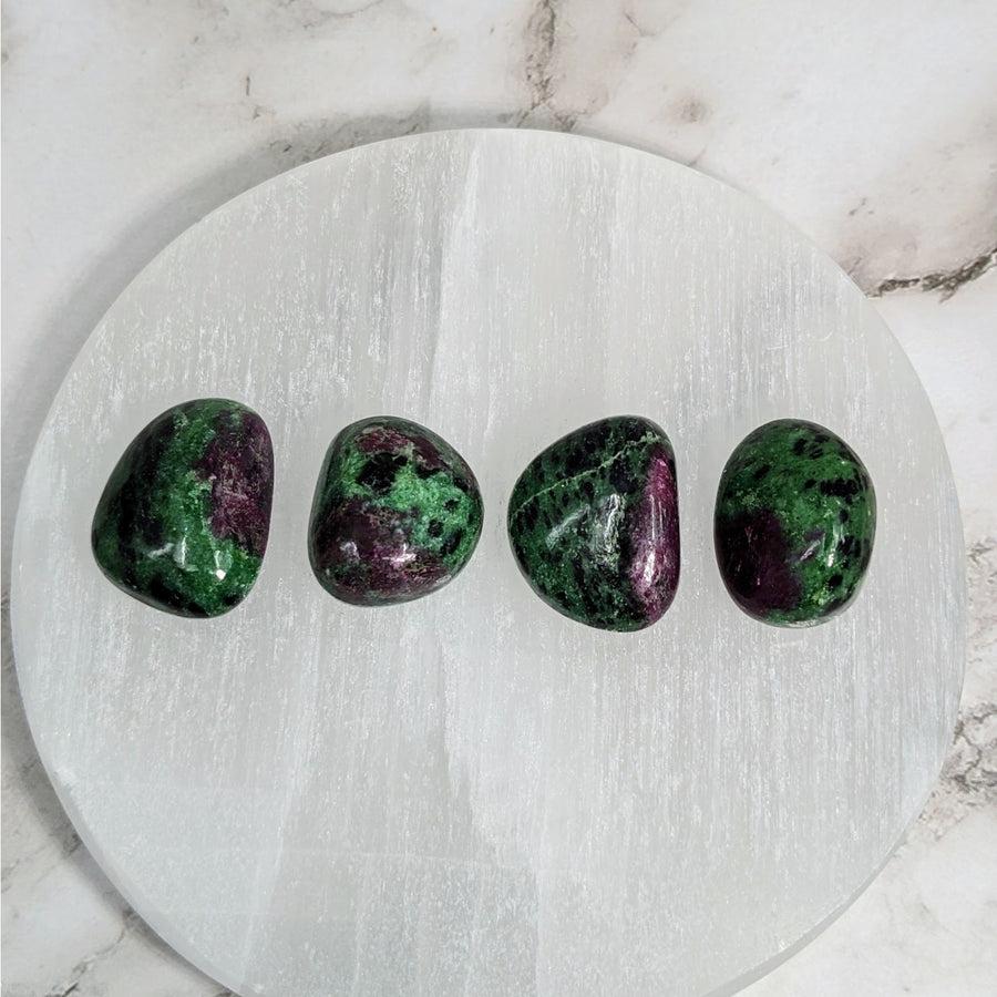 Three green and purple tumbled stones on white marble plate - Ruby Zoisite .9-1’ #LV4057