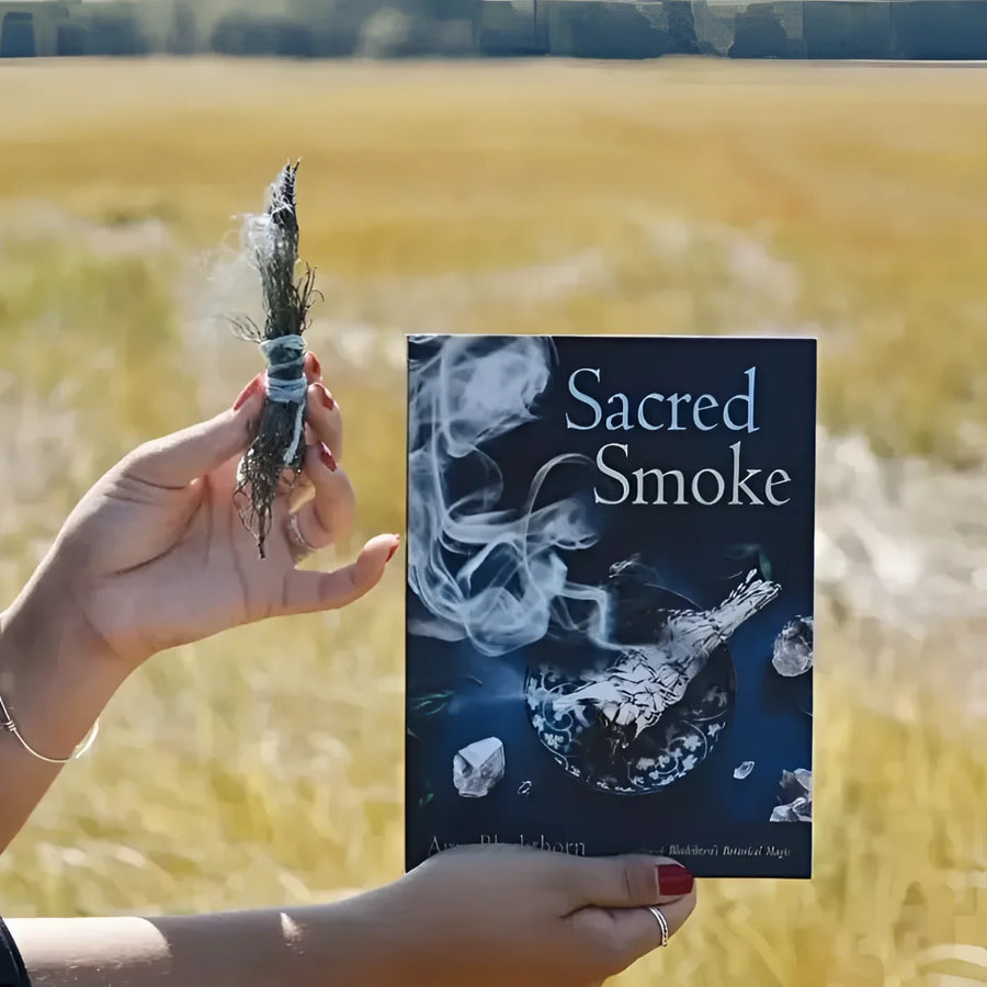 Person holding Sacred Smoke Book by Amy Blackthorn #Q007 in their hand