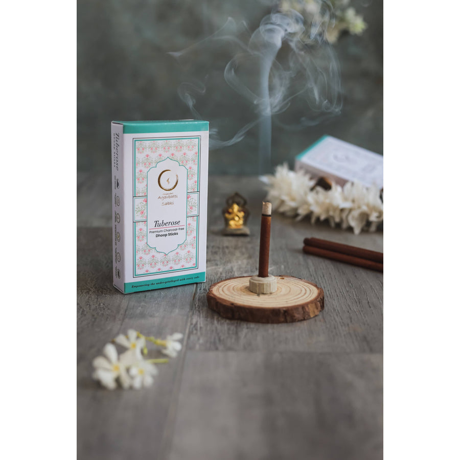Burning incense stick on wooden holder from Saffron-Sandalwood Musk Tuberose Combo Pack