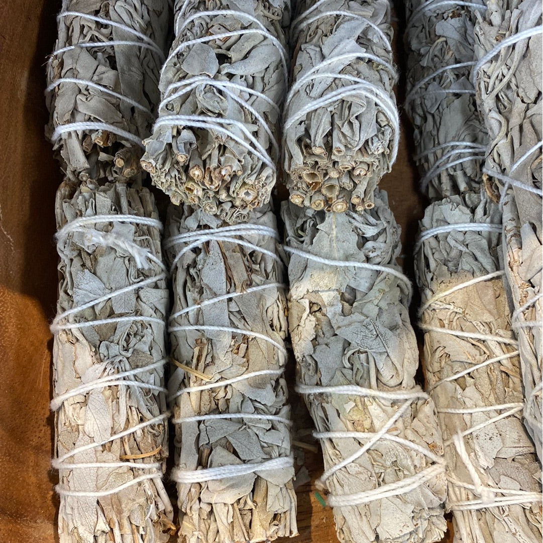 Bundles of white sage tied with string from the Sage & Herb Cleansing Bundle K120