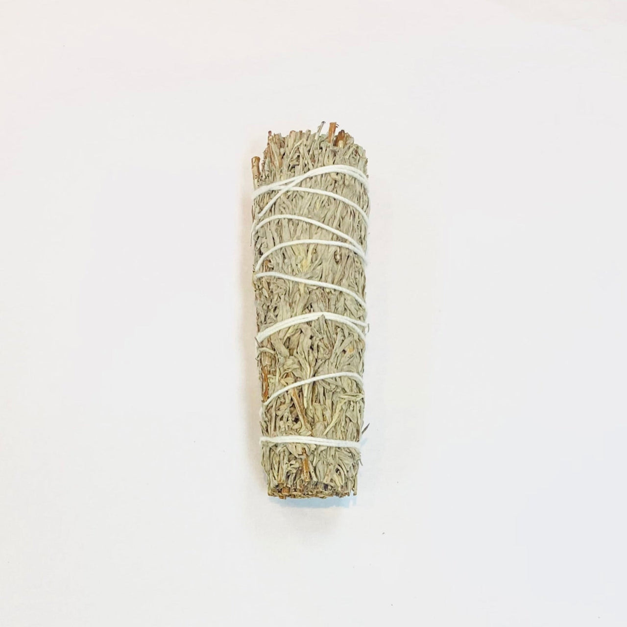 Dried sage bundle wrapped in white string for cleansing rituals and aromatic use