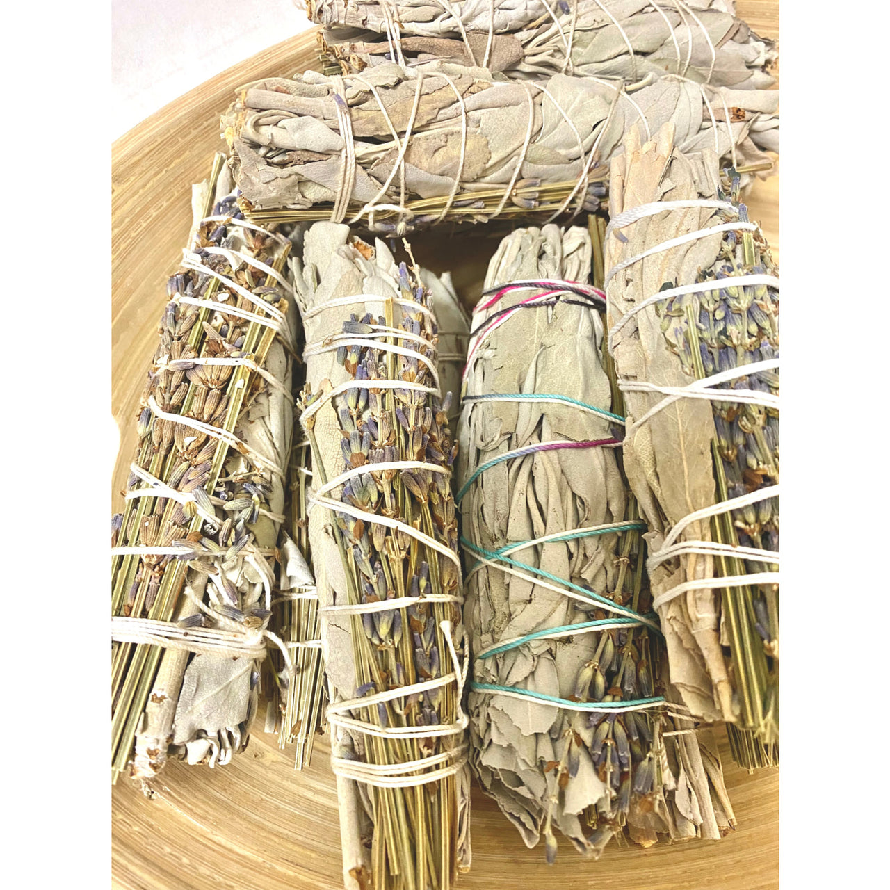 Bundled sage smudge sticks wrapped with white string in Sage & Herb Cleansing Bundle