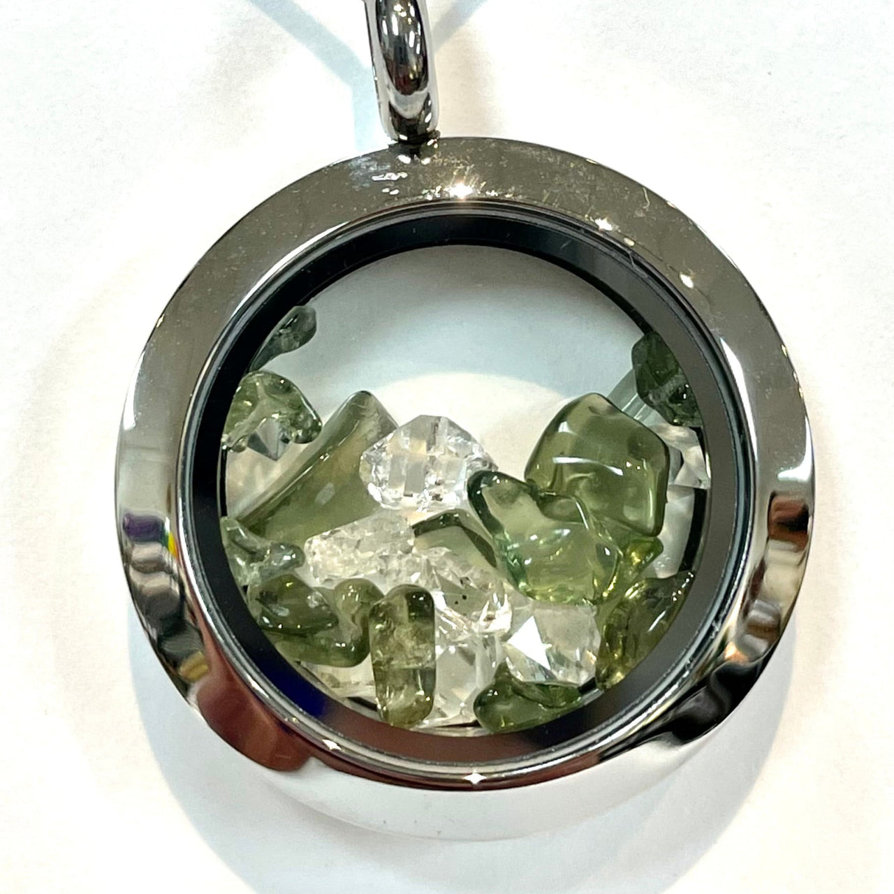 Round silver locket with clear and green crystals from Moldavite and Phenacite Locket Pendant