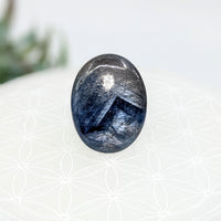 Thumbnail for Polished oval sapphire palm stone with silvery-blue chatoyancy, 1’’ Palm Stone #LV7080