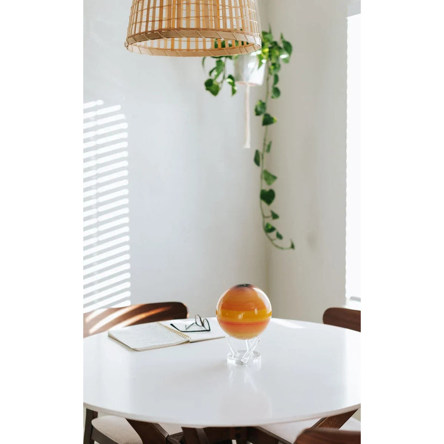 Orange and yellow glass sphere from Saturn Rotating Mova Globe with earth relief map
