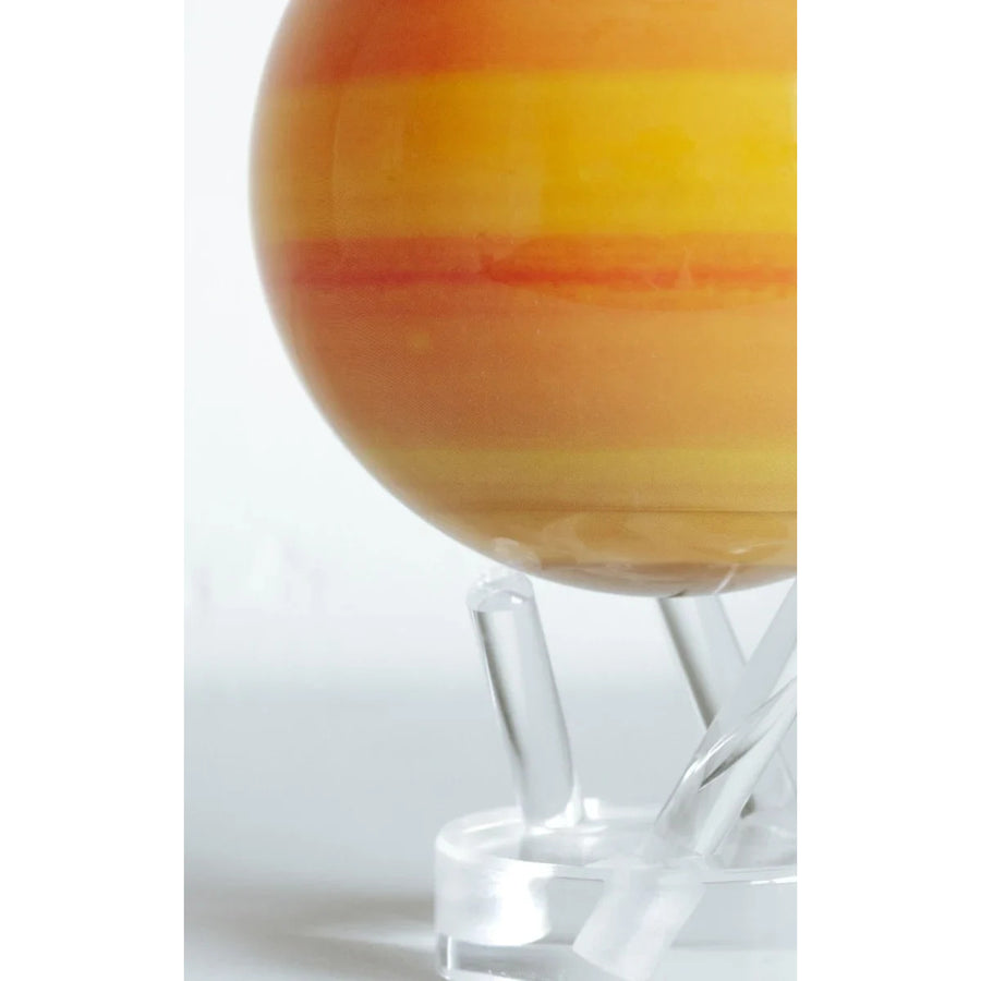 Striped orange and yellow glass sphere from Mova Globe with Earth Relief Map display