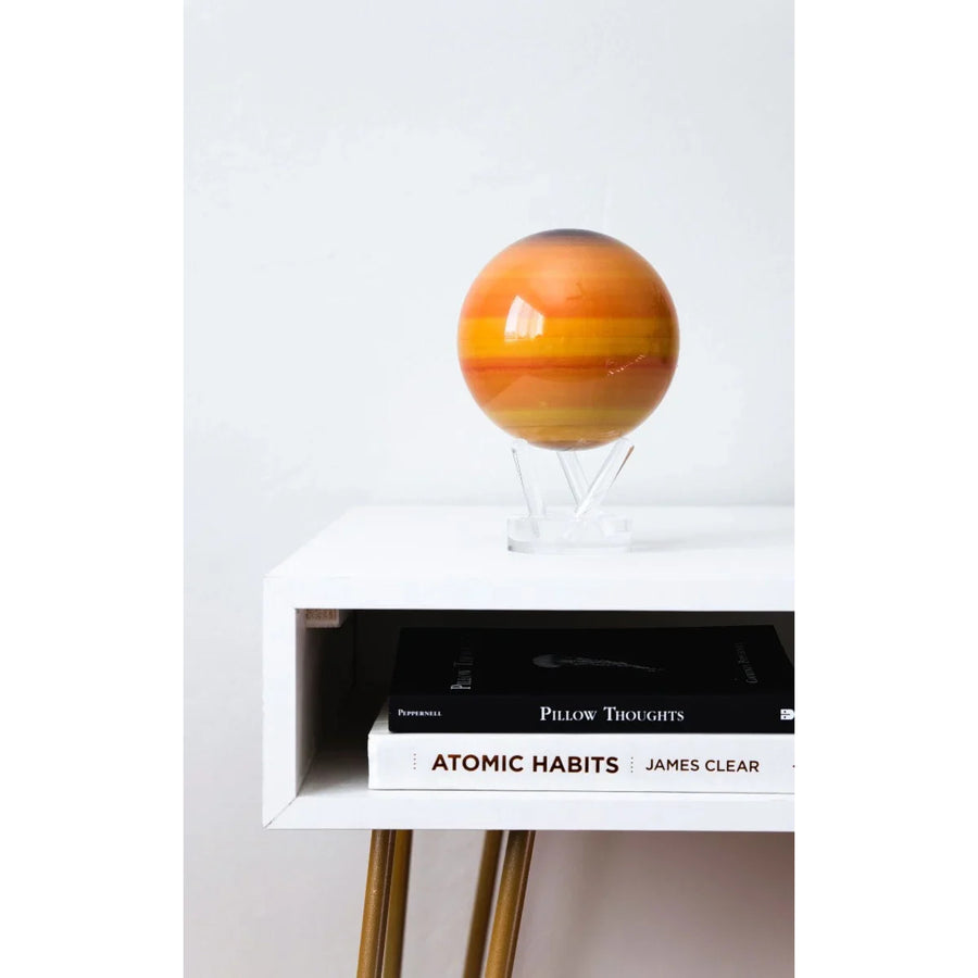 Striped orange sphere Mova Globe with Earth Relief Map rotating on acrylic base