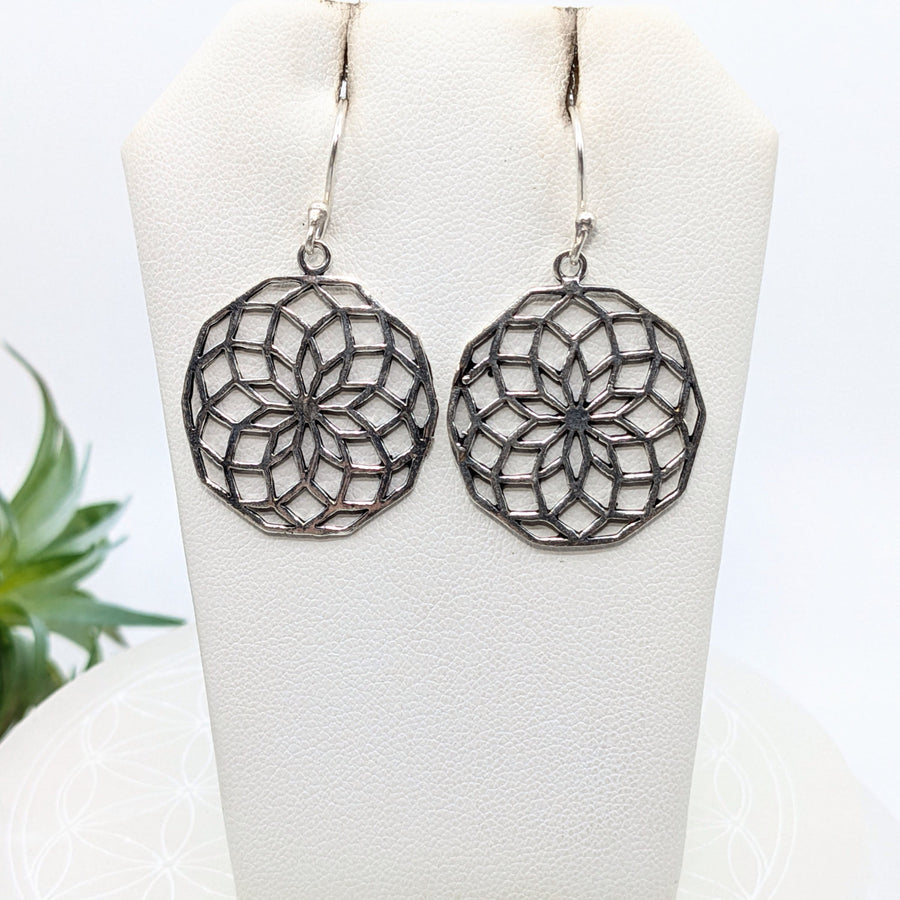 Silver mandala-style 1’’ brass earrings with intricate geometric floral patterns