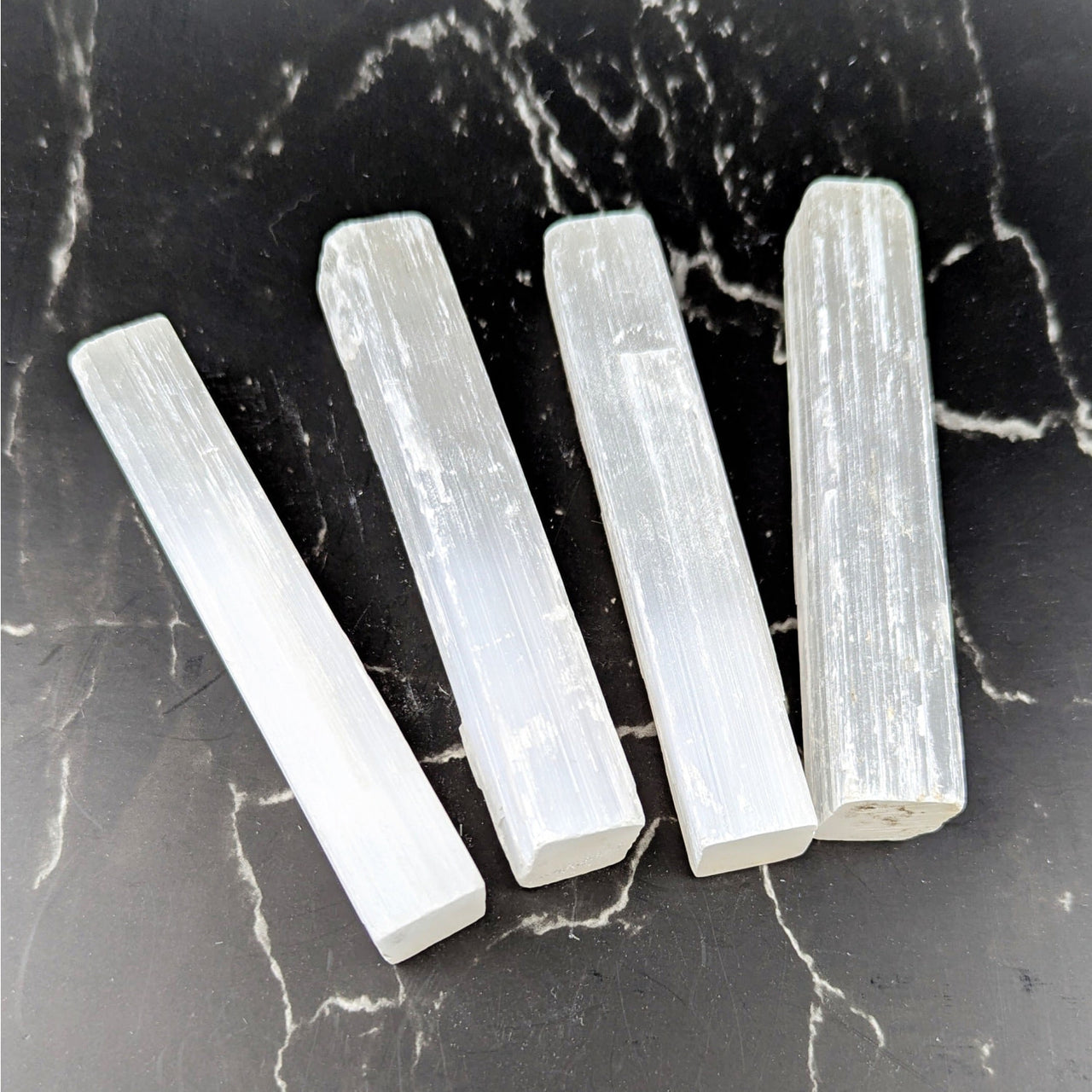 Four translucent white selenite crystals with smooth rectangular facets and internal striations, 3.75-4 inch rough stick #BC0712