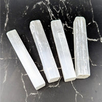 Four translucent white selenite crystals with smooth rectangular facets and internal striations, 3.75-4 inch rough stick #BC0712