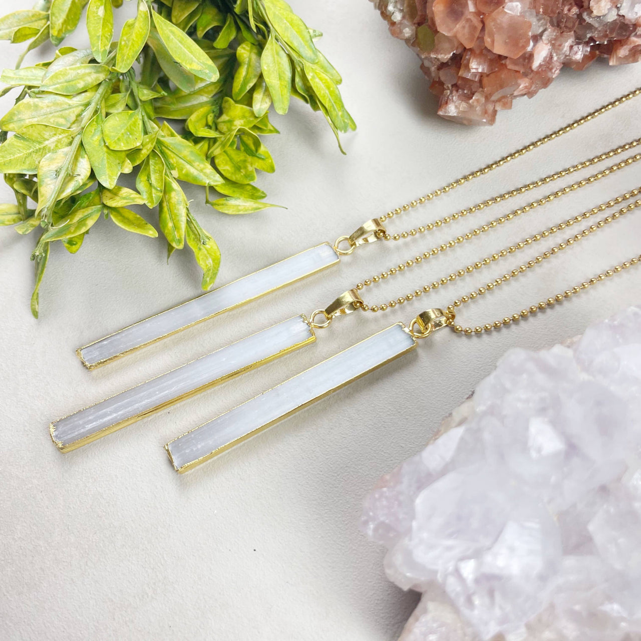 Three selenite bar gold-sided necklaces with frosted pendants